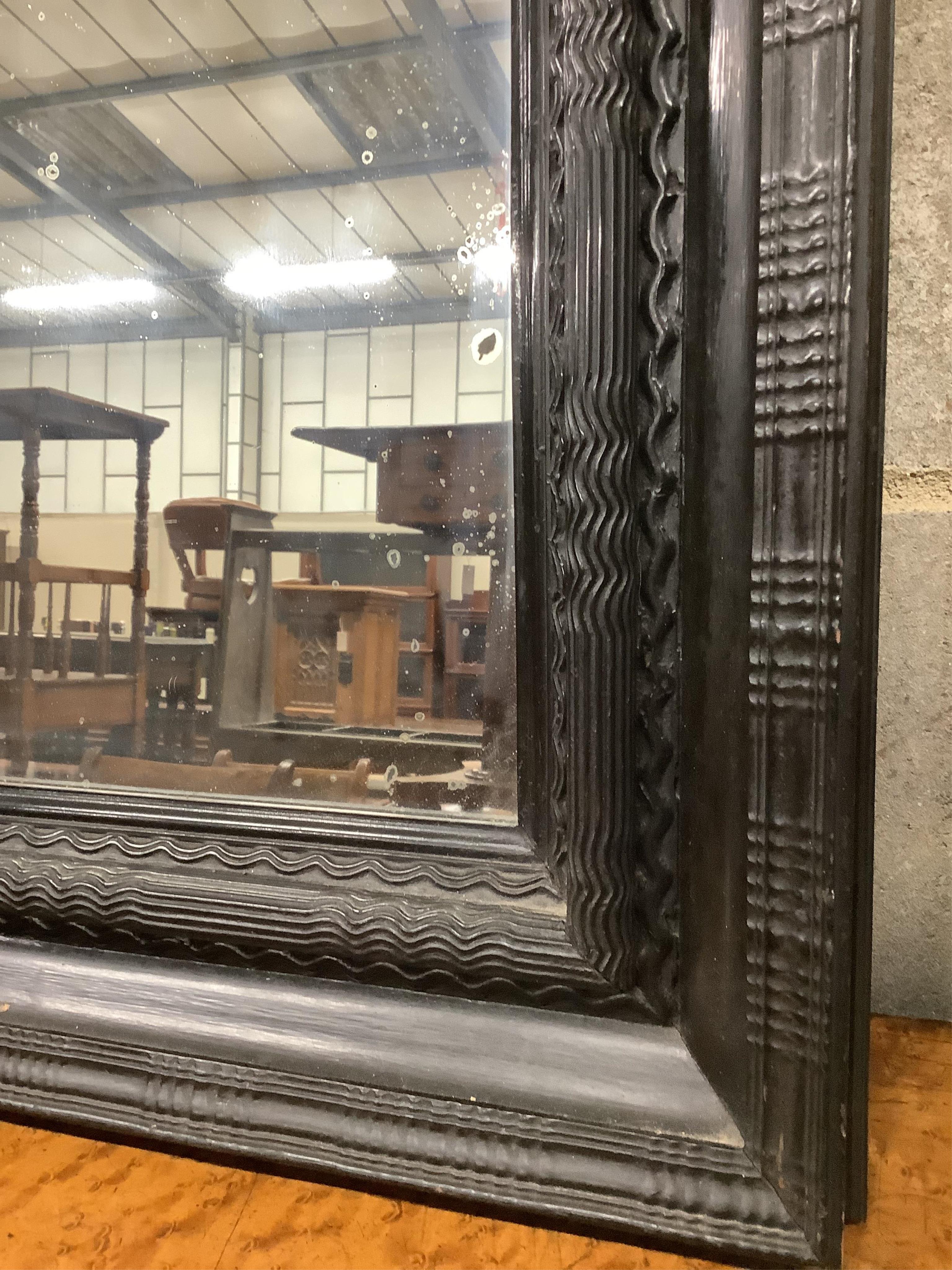 A Dutch ebonised ripple moulded frame, now a wall mirror, width 61cm, height 74cm. Condition - good